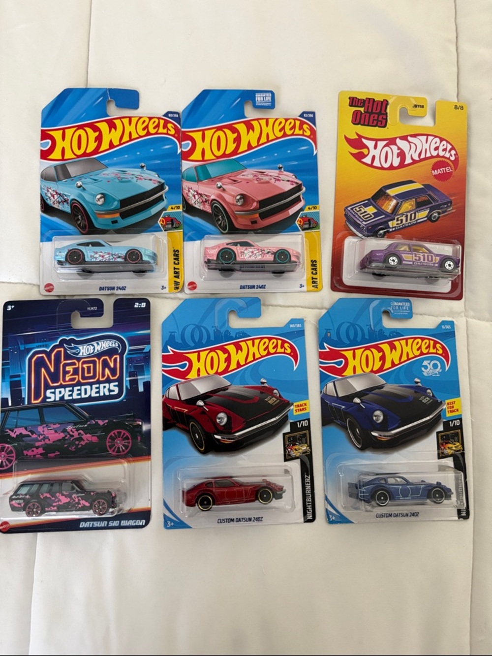 6 Assorted Datsun vehicles - Blue, Pink, Red, Purple